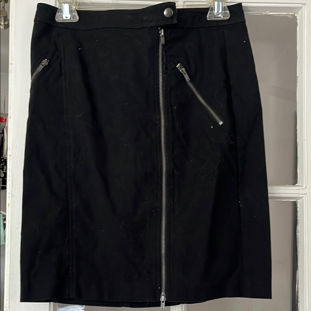 Sturdy material with zipper and button detail.